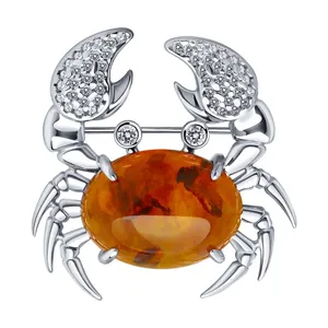 Брошь из серебра с янтарём и фианитами